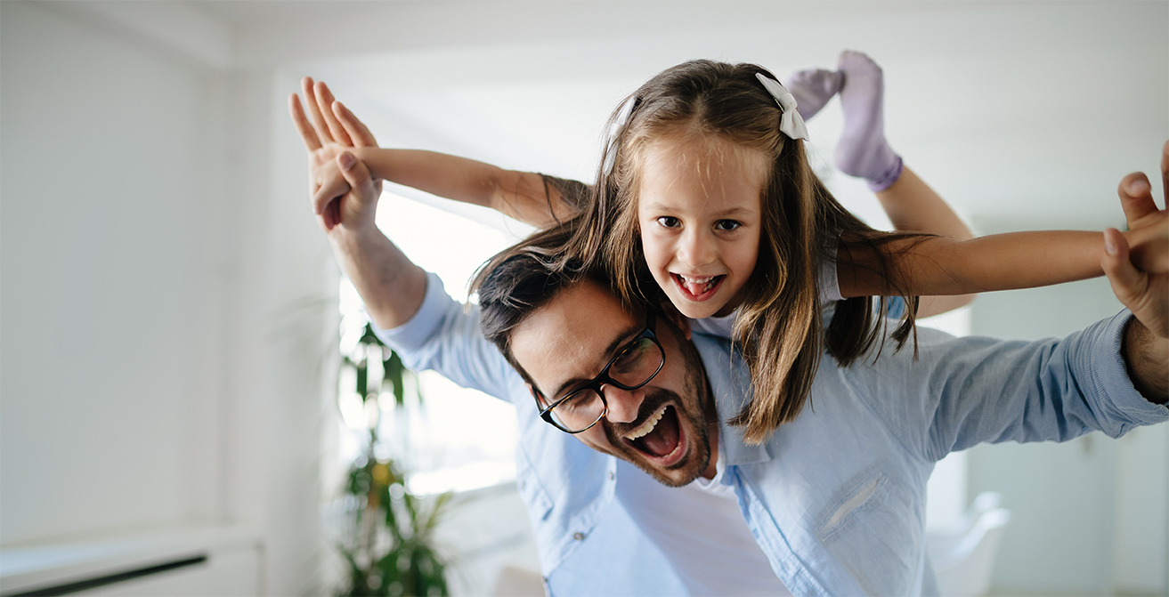 Dad and daughter smiling
