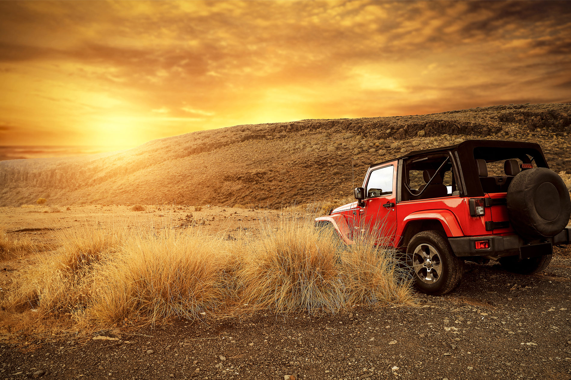Jeep on hill at sunset