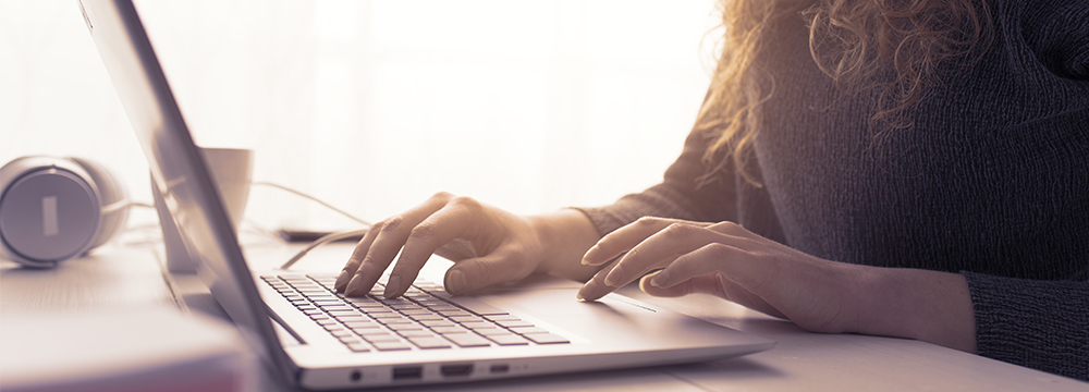 Hands typing on computer