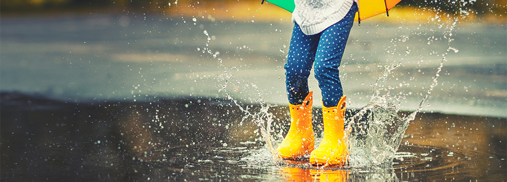 Child playing in a puddle.