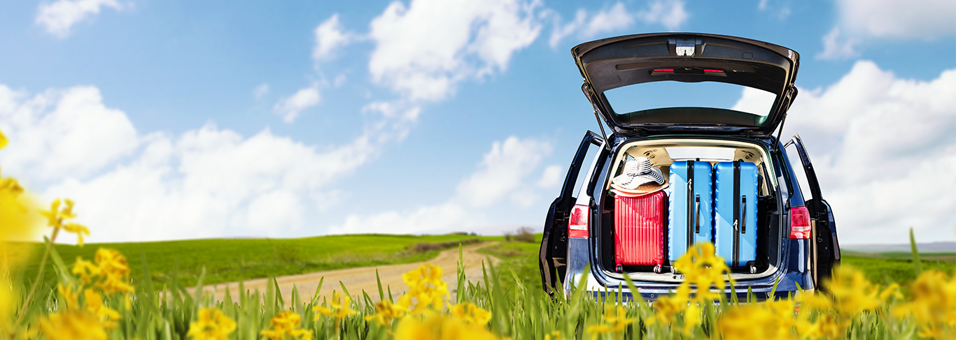 Car with trunk open on country road. Click here for auto loans.