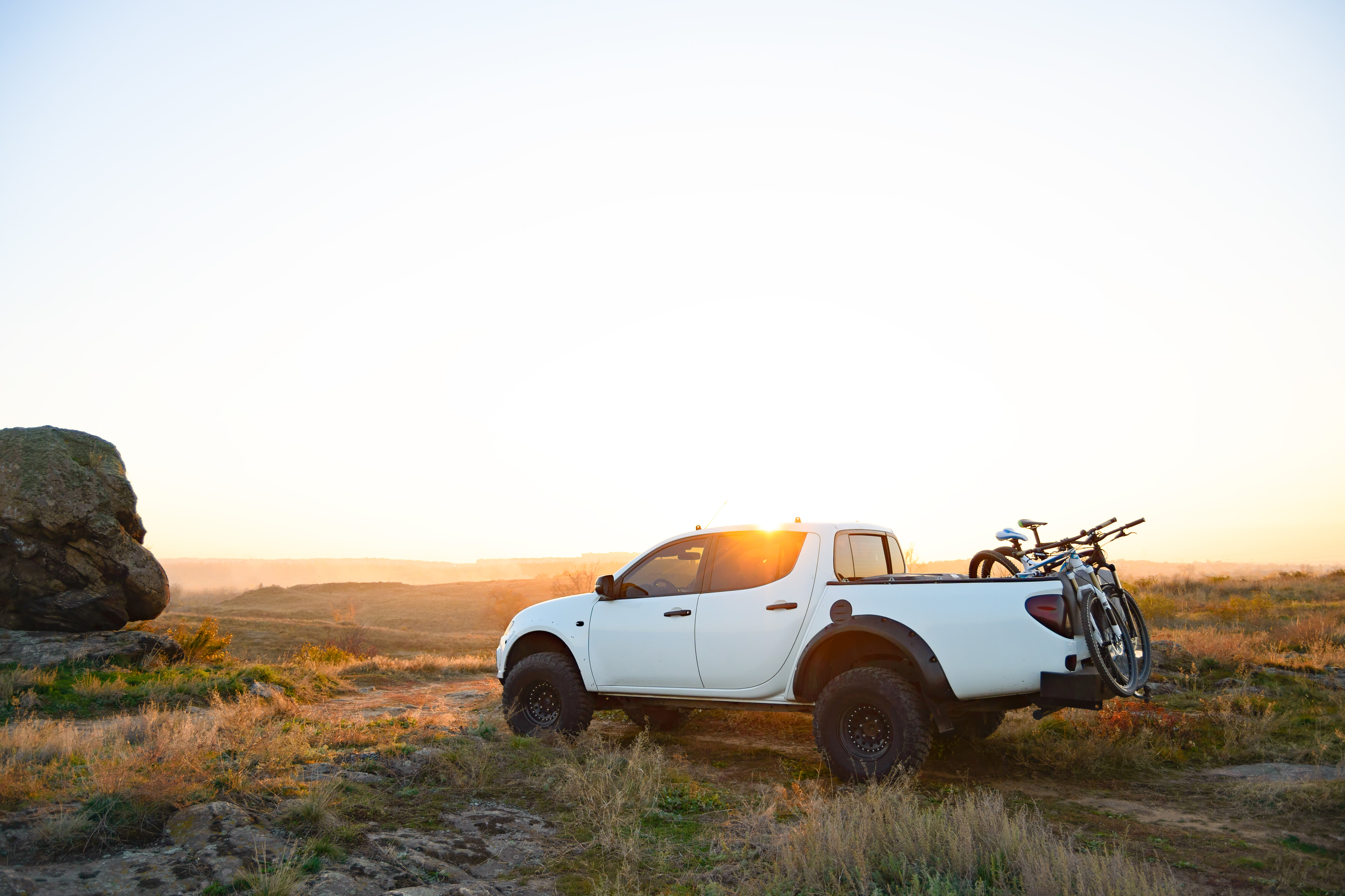 Truck in field with sunset