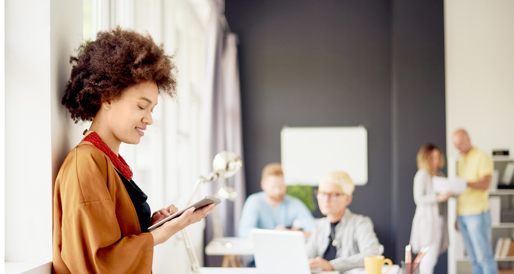 Young woman on tablet in office