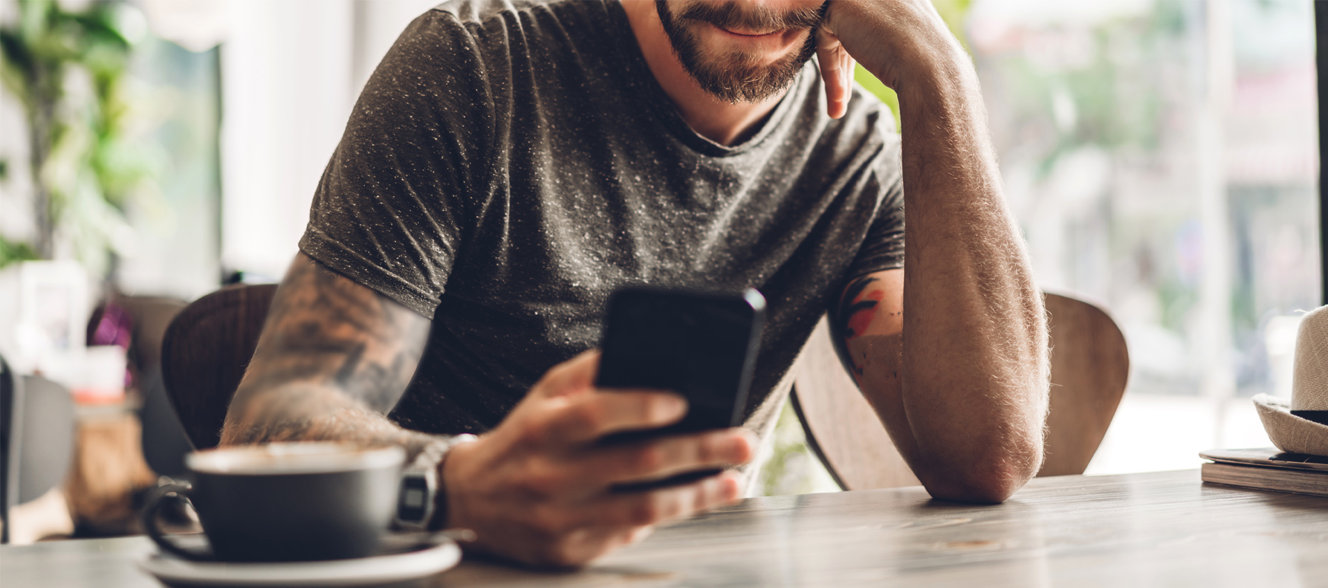 Young man on phone. Click to get the App.